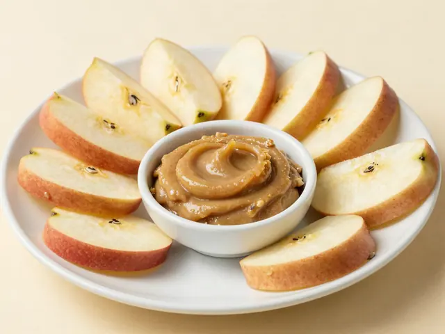 Apple slices around a dish of sunflower seed butter