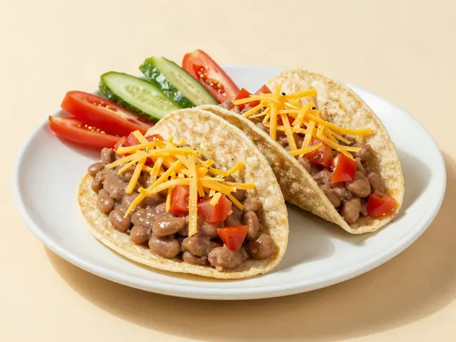 Two soft bean and cheese tacos with veggie sticks on a plate