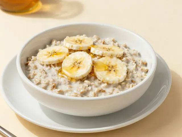 Bowl of oatmeal topped with banana slices and honey