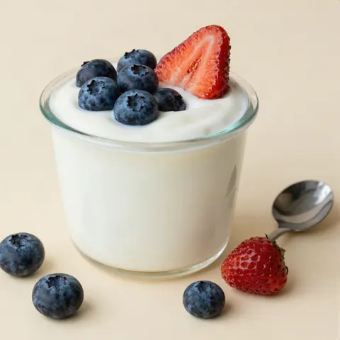 Cup of yogurt topped with fresh berries